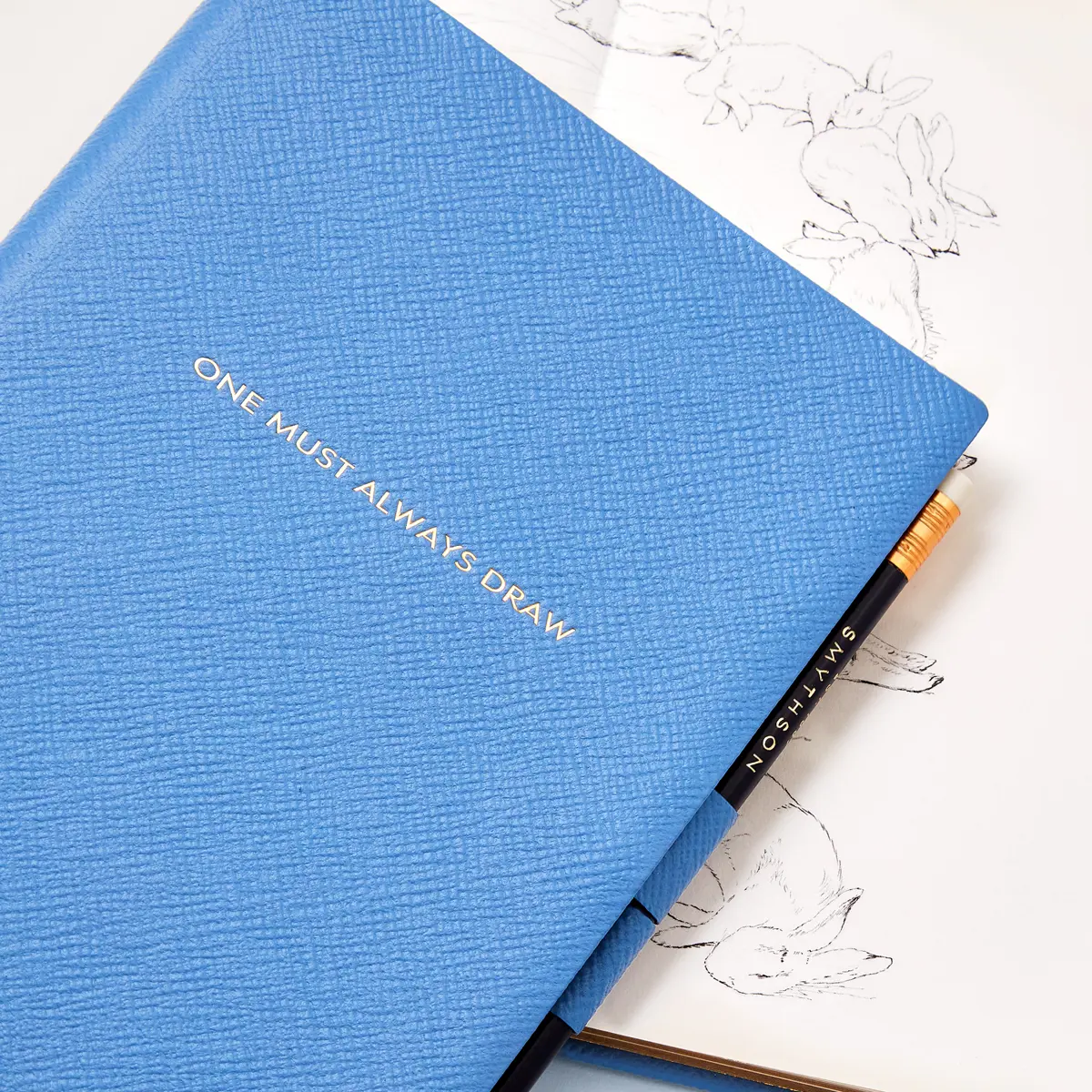 SQUARE | Smythson X Peter Rabbit And Friends Soho Sketchbook In Panama, Nile Blue, £225 | $375