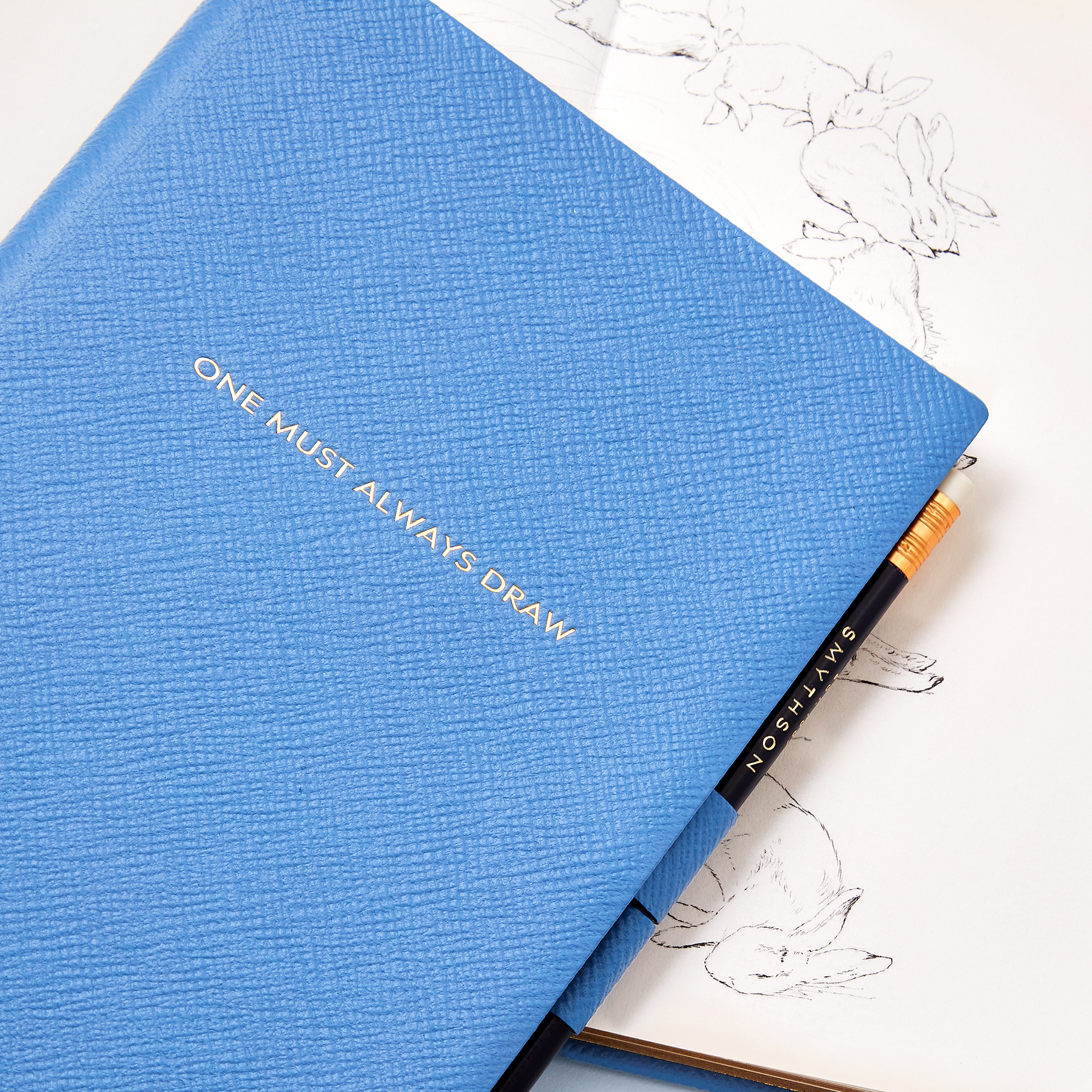 SQUARE | Smythson X Peter Rabbit And Friends Soho Sketchbook In Panama, Nile Blue, £225 | $375